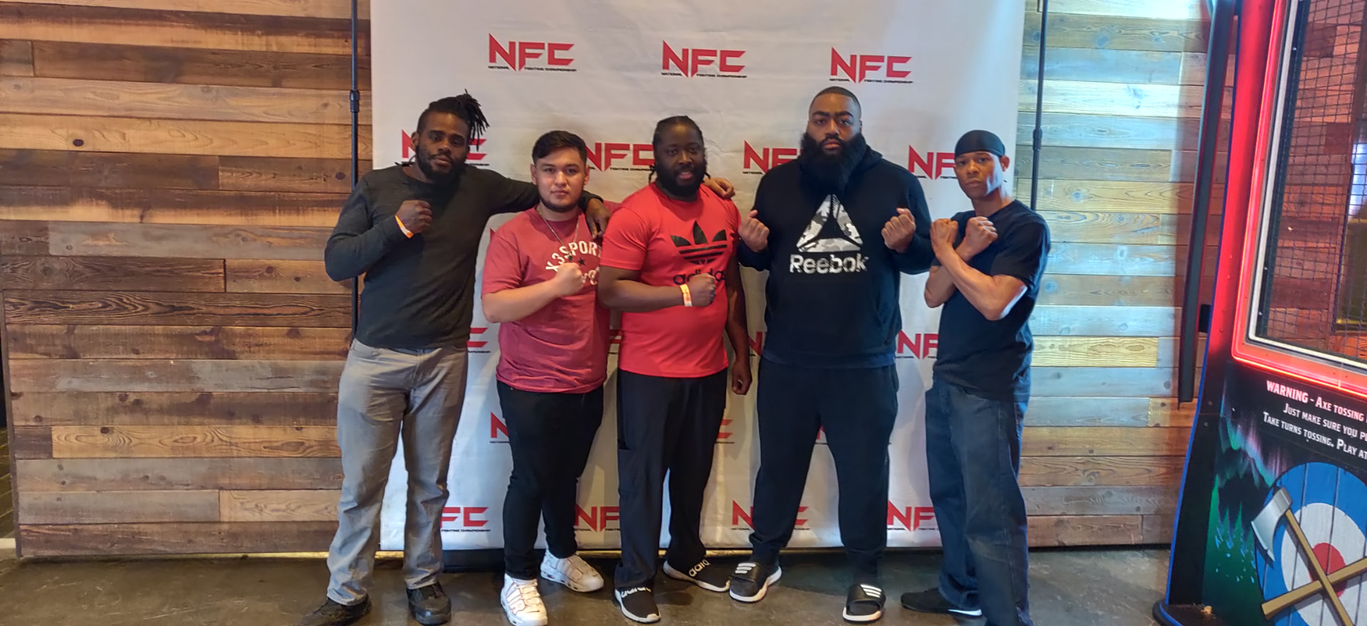Josh Bell with fighters at an NFC event